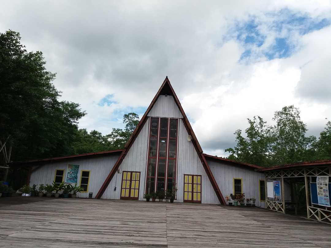 The present cathedral's white A-frame gable with its vertical window strip, yellow doors and the boardwalk in front